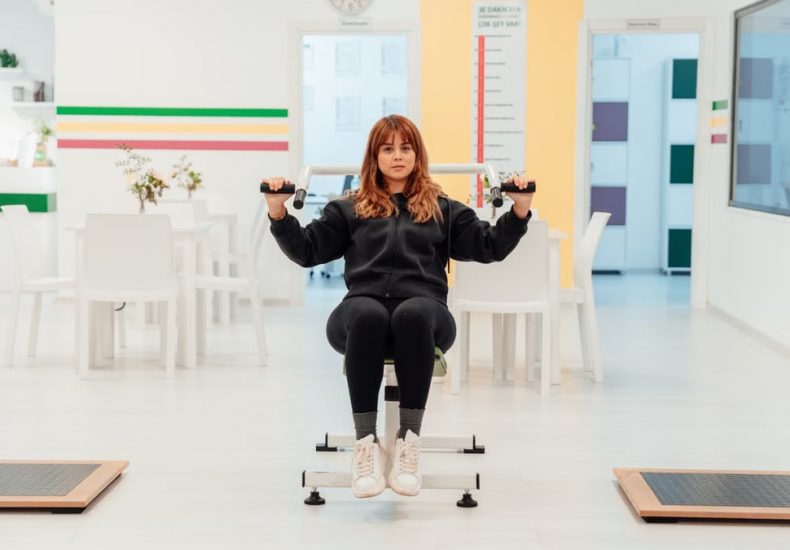 A woman exercises in a bright rehabilitation center, focusing on recovery and wellness.